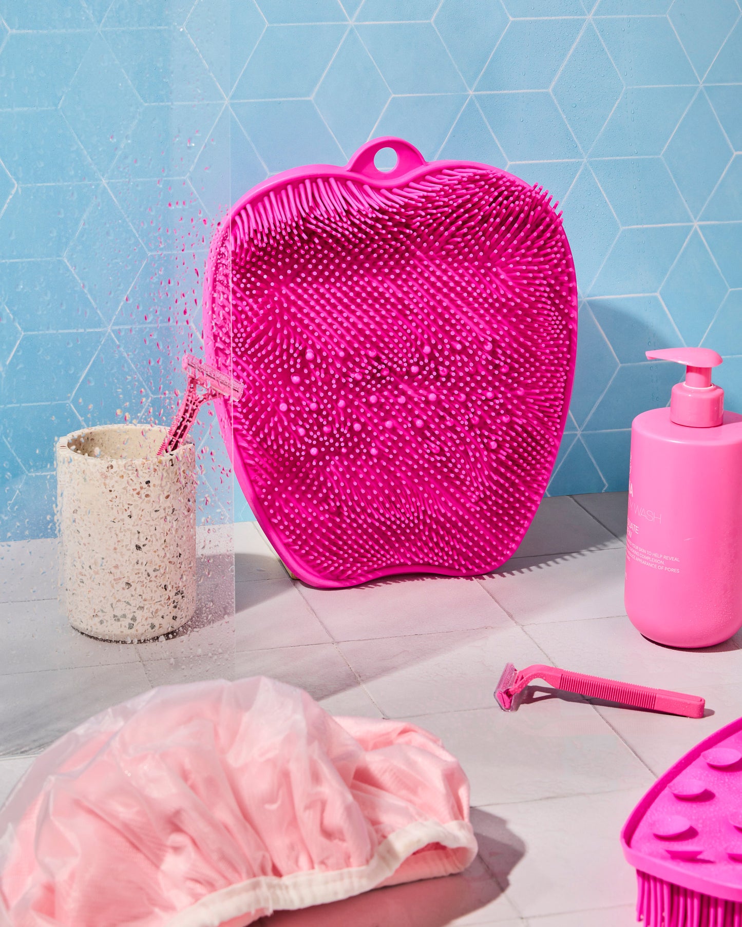 The Footsie foot scrubber placed on shower floor